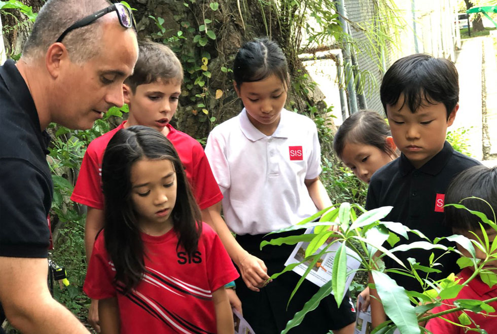 teacher and students learning about plants